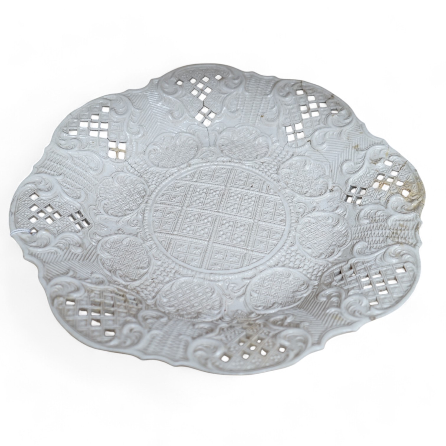 An 18th century white salt-glaze dish, diameter 31cm. (a.f.). Condition - poor, significant cracks and repair